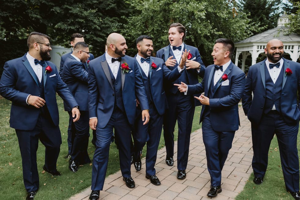 Salisbury Cathedral wedding party in navy three-piece suits